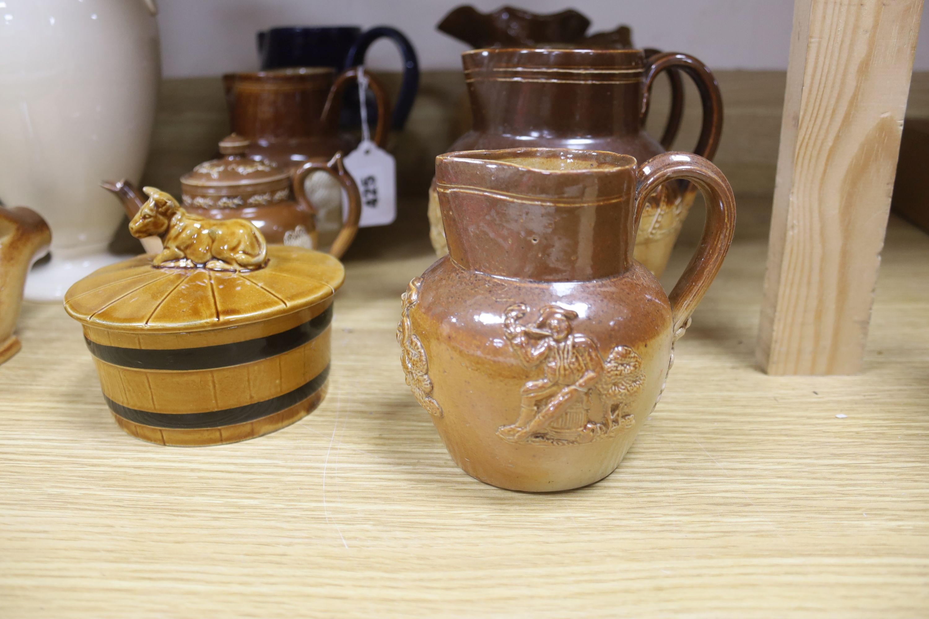 A group of Doulton stoneware: jugs, a teapot, butter dish and a pipe salesman's model